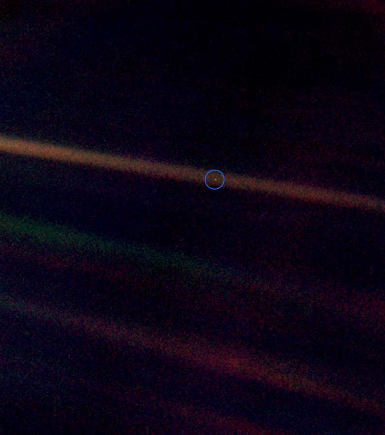 This is the
"Pale Blue Dot" photograph of the Earth taken by the Voyager 1 spacecraft on July 6, 1990.
The Earth is the relatively bright speck of light about halfway across the uppermost
sunbeam. (shown here inside a blue circle) This is the "Pale Blue Dot" photograph of the
Earth taken by the Voyager 1 spacecraft on July 6, 1990. The Earth is the relatively
bright speck of light about halfway across the uppermost sunbeam. (shown here inside a
blue circle)